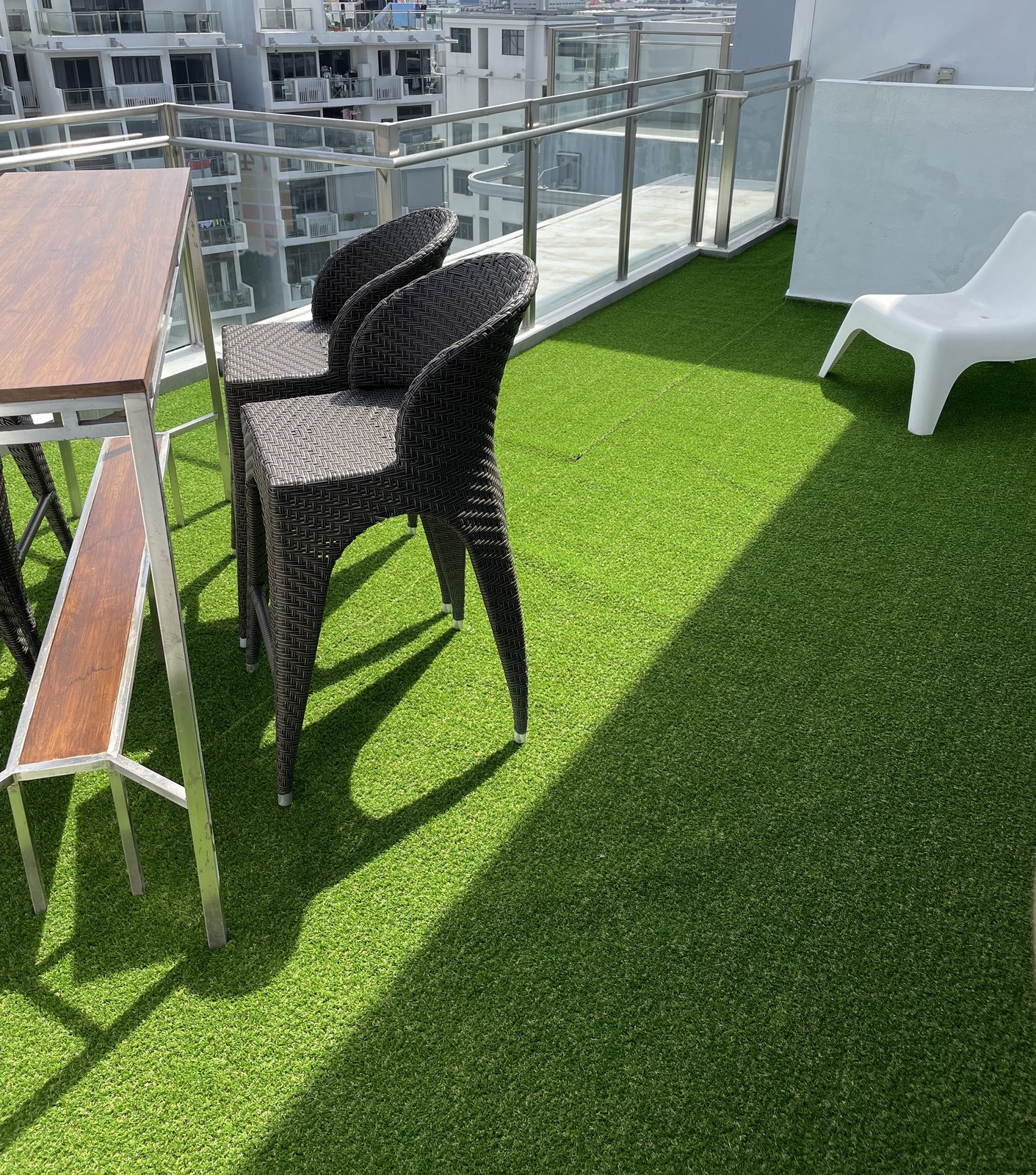 Condo rooftop with artificial grass and an outdoor kitchen counter