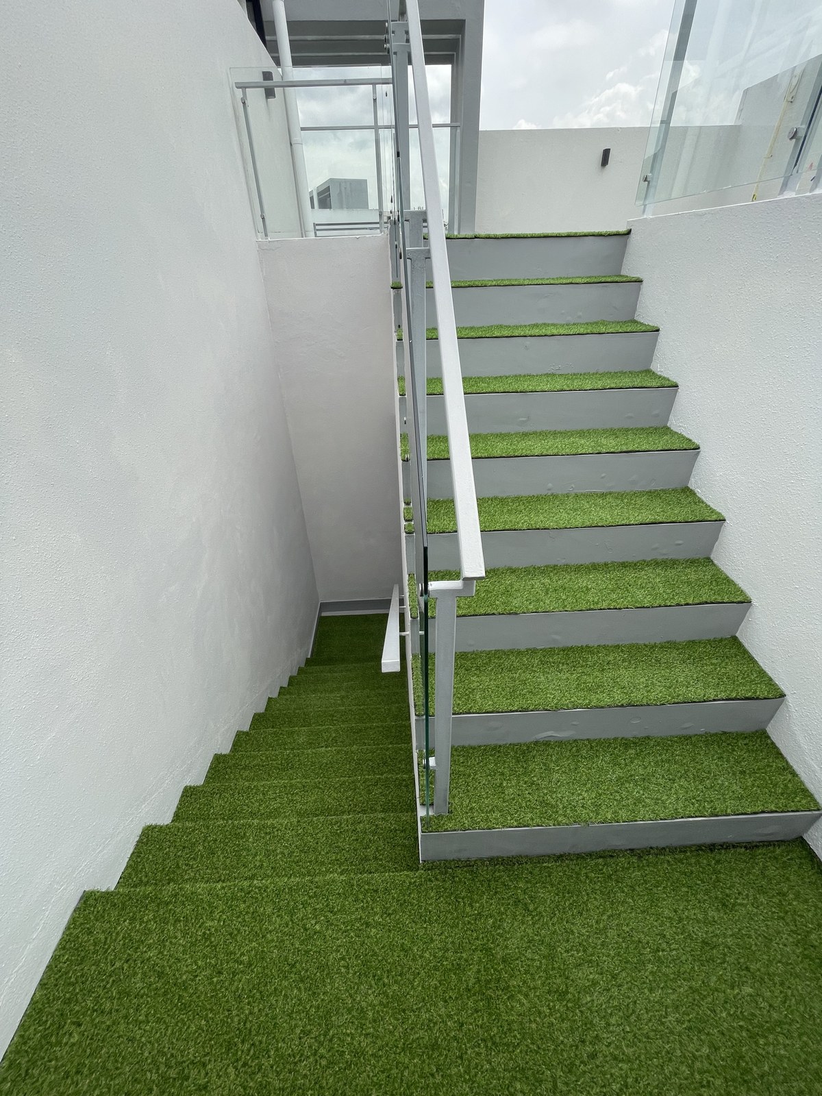 Staircase with artificial grass treads in a landed home